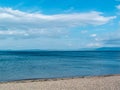 Peble beach blue sea hills and blue sky and cold day in Largs Scotland Royalty Free Stock Photo