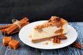 Pecan caramel cheesecake with a dark background