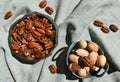 Pecan in ceramic bowl. Unpeeled nuts in shell deep green rustic porcelain. Organic raw healthy diet. Top close up view