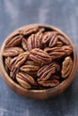 Pecan nut close-up in a round wooden cup on a on wooden table background.Nuts and seeds. .Healthy fats.Heap shelled