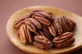Pecan nut close-up in spoon on brown background.Healthy fats.Heap shelled Pecans nut closeup. Ingredient of the keto