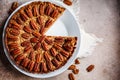 Pecan Pie on white dish, gray-brown background, copy space. Vegan dessert concept Royalty Free Stock Photo