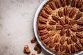 Pecan Pie on white dish, gray-brown background, top view. Vegan dessert concept Royalty Free Stock Photo