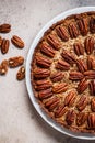 Pecan Pie on white dish, gray-brown background, top view. Vegan dessert concept Royalty Free Stock Photo