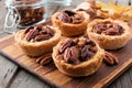 Pecan tarts close up on a wooden server Royalty Free Stock Photo