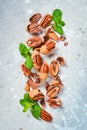 Pecans in shell on a stone background. Assortment of nuts. Royalty Free Stock Photo