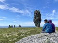 Pechora-Ilych Nature Reserve, Northern Ural, Russia, July, 12, 2021.People looking for stone pillars of weathering on the Manpupun