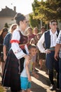 PECINCI, SERBIA - JUNE 19, 2022: Selective blur on a Young woman wearing a traditional Serbian costume getting prepared to dance