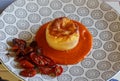 Pecorino cheese souffle on tomato sauce in decorated plate Royalty Free Stock Photo