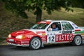 Vintage rally cars speeding across the city