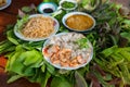 Peculiar herbs salad in Kon Tum, Vietnam. Using the leaves to make a cone-shaped container to put the food in, and use some bacon, Royalty Free Stock Photo