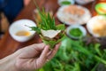 Peculiar herbs salad in Kon Tum, Vietnam. Using the leaves to make a cone-shaped container to put the food in, and use some bacon, Royalty Free Stock Photo