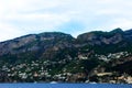 Scene in Amalfi coast with rocky mountains, scattered white buildings, sea and cloudy sky Royalty Free Stock Photo