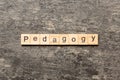 Pedagogy word written on wood block. Pedagogy text on cement table for your desing, concept Royalty Free Stock Photo