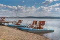 Pedal boats on the shore of the lake and sky with clouds. Vacation and lifestyle concept Royalty Free Stock Photo