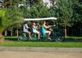 Pedal car for the family. Bicycle for six. Means of transportation in the park. Walkway in the park at the resort. Georgian resort