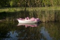 Pedalo or Paddle Wheel Boat in the shape of dolphins in reeds of a lake Royalty Free Stock Photo