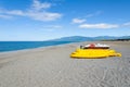 Pedalos and kayaks on a gravel beach