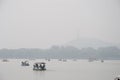 Peddle boats in haze on lake in China