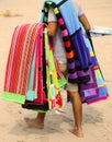 Peddler of towels and beach towels on the beach in summer