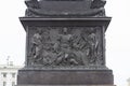 Pedestal of Alexander Column on Palace Square decorated with bas relief winged angels, breastplate armor, lion military symbols