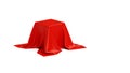 Pedestal covered with luxurious red cloth on white background in studio