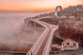 Pedestrian bicycle bridge, Kyiv Ukraine, dawn, heavy fog spreads over the Dnieper river, aerial view