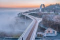 Pedestrian bicycle bridge, Kyiv Ukraine, dawn, heavy fog spreads over the Dnieper river, aerial view