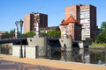 Pedestrian bridge and buildings on the banks of the river Pregel. Kaliningrad, Russia Royalty Free Stock Photo