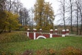 Pedestrian bridge in the city park. Yellowed autumn leaves are all around Royalty Free Stock Photo