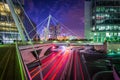 Pedestrian bridge and modern buildings adjacent to a road at night at La DÃÂ©fense, in Paris, France. Royalty Free Stock Photo