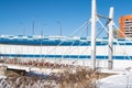 A pedestrian bridge over a frozen river, locks on the railing, signs of loyalty to the newlyweds, love forever