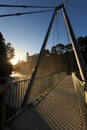 Pedestrian bridge over waterfall at sunset Royalty Free Stock Photo