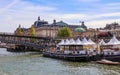 Pedestrian bridge Passerelle LÃÂ©opold-SÃÂ©dar-Senghor over Seine river, boats and historic buildings of Paris France Royalty Free Stock Photo