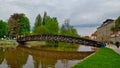 Pedestrian bridge upon river in South Bohemian city of Ceske Budejovice during cloudy spring weather