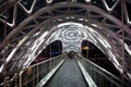 Pedestrian bridge. Steel glass construction illuminated numerous lights. Architecture concept. Bridge in Tbilisi. Curvy