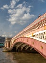 A pedestrian crosses Blackfriars bridge, illuminated by bright afternoon summer sunlight Royalty Free Stock Photo