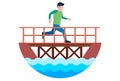 a pedestrian crosses the river through a wooden bridge.