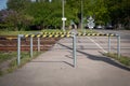 Pedestrian crossing across railway lines. Safety barriers and warning tapes. Urban environment Royalty Free Stock Photo