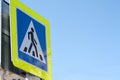 Pedestrian crossing blue sign with yellow light-reflecting frame Royalty Free Stock Photo