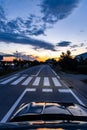 Pedestrian crossing in the evening, seen from oncoming car, driving too fast Royalty Free Stock Photo