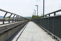 Pedestrian crossing on the highway bridge over the river in West Germany, an empty pavement visible. Royalty Free Stock Photo