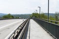 Pedestrian crossing on the highway bridge over the river in West Germany, an empty pavement visible. Royalty Free Stock Photo