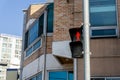 Pedestrian crossing lights on the pole in the town is showing the red standing man symbol Royalty Free Stock Photo