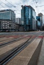 Pedestrian crossing over the road and tram track on the background of office buildings