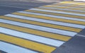 Pedestrian crossing over the roadway in the form of yellow and white stripes Royalty Free Stock Photo