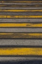 Pedestrian crossing with semi-erased white and yellow stripes