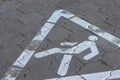 Pedestrian crossing sign in a white triangle on a stone tile in the street. A symbol of caution for populations including students