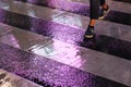 Pedestrian crossing the street on a rainy evening