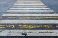 Pedestrian crossing, yellow and white stripes on wet asphalt in the form of texture and substrate Royalty Free Stock Photo